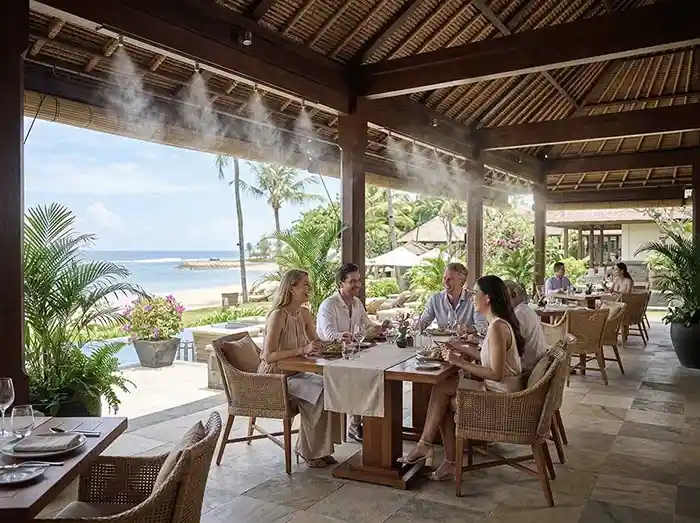 Guests dining comfortably in a cooled outdoor terrace